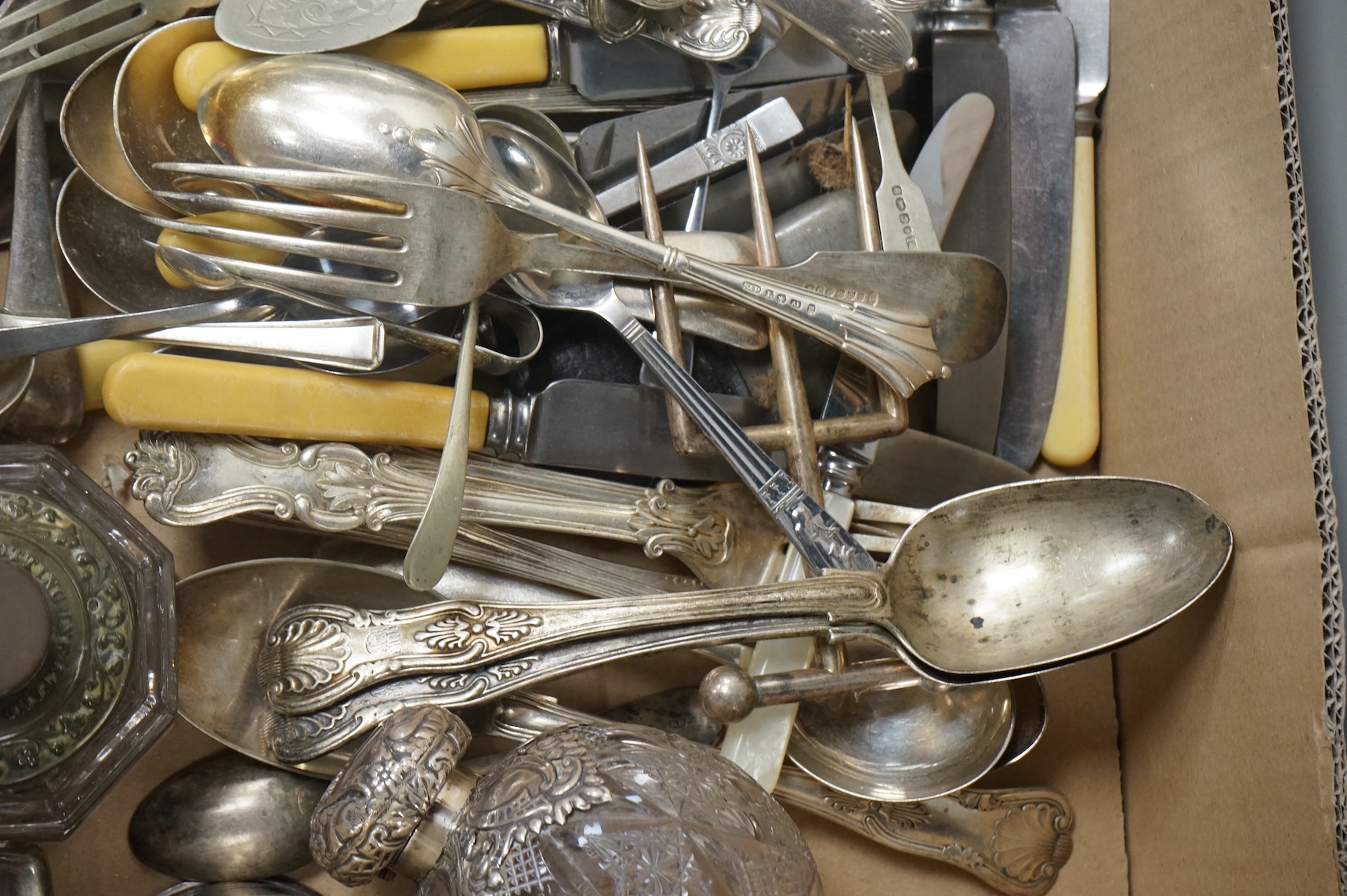 A pair of Victorian silver King's pattern table spoons by George Adams, London, 1858, a silver teaspoon, a mounted glass scent bottle, a silver cigarette case, a continental canister with inset coin lid, and assorted pla